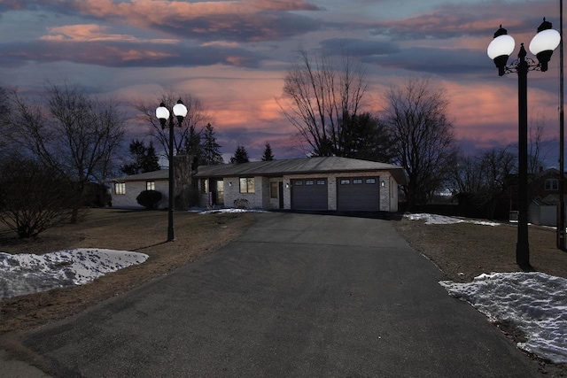 ranch-style house with driveway and an attached garage