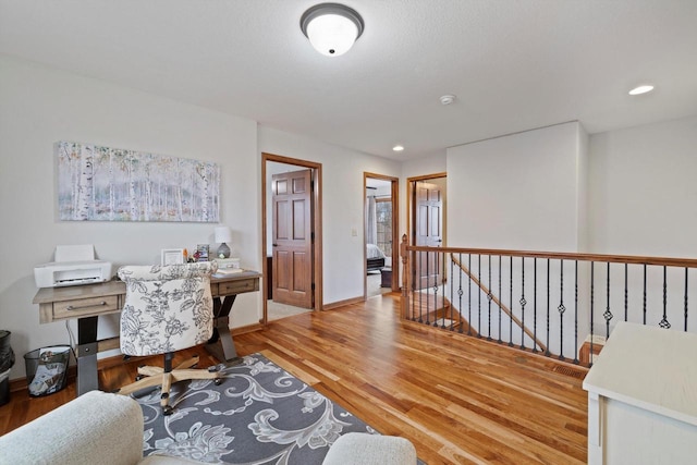 office space with recessed lighting, baseboards, and wood finished floors