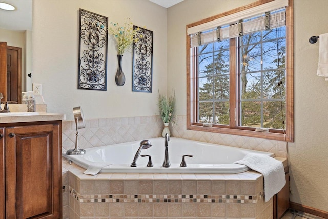 full bath with a garden tub and vanity