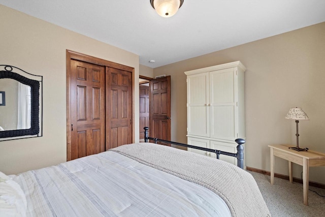 bedroom featuring a closet, carpet flooring, and baseboards