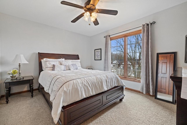 bedroom with ceiling fan, baseboards, and light colored carpet