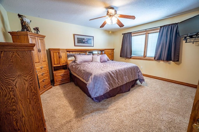 bedroom with a textured ceiling, ceiling fan, baseboards, and light colored carpet