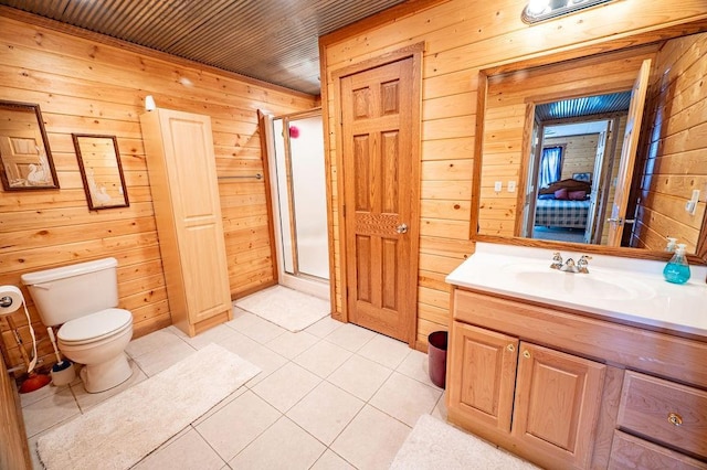 bathroom featuring toilet, a shower stall, wooden walls, and vanity