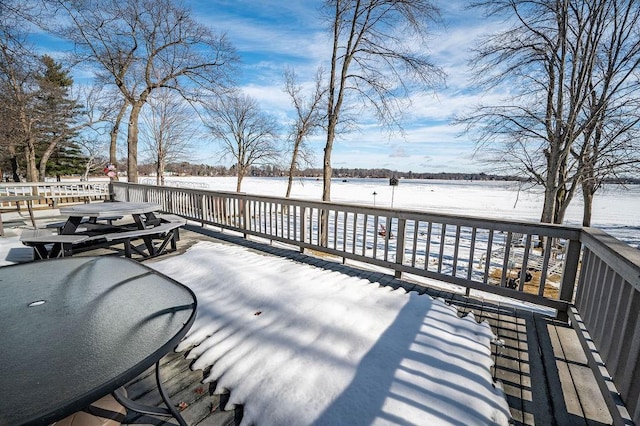 snow covered deck with outdoor dining space