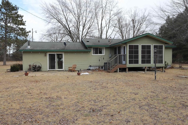 rear view of property with central AC and a sunroom