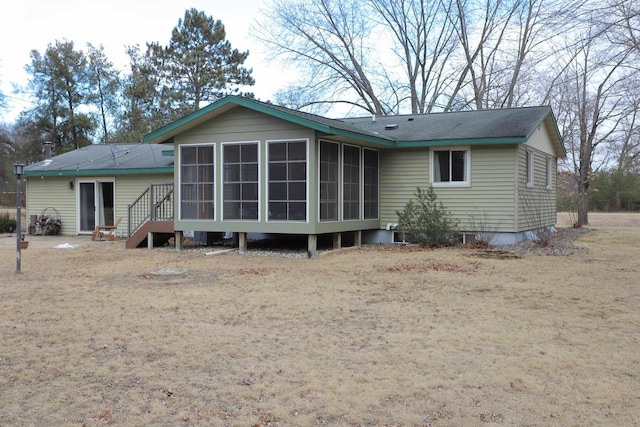 back of property with a sunroom