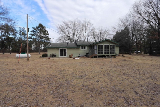 back of property featuring a sunroom