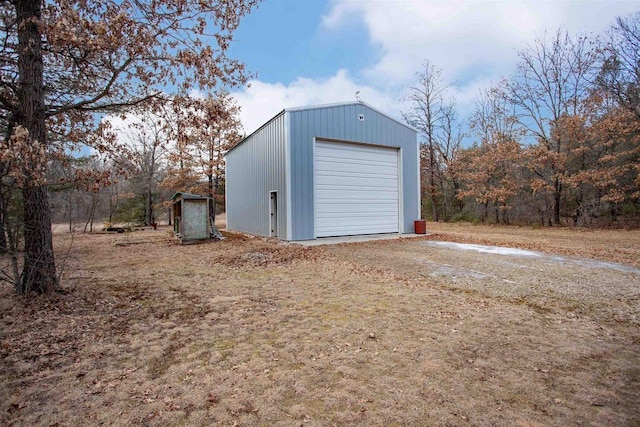 detached garage with dirt driveway