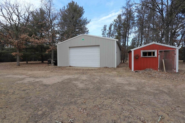 detached garage featuring driveway