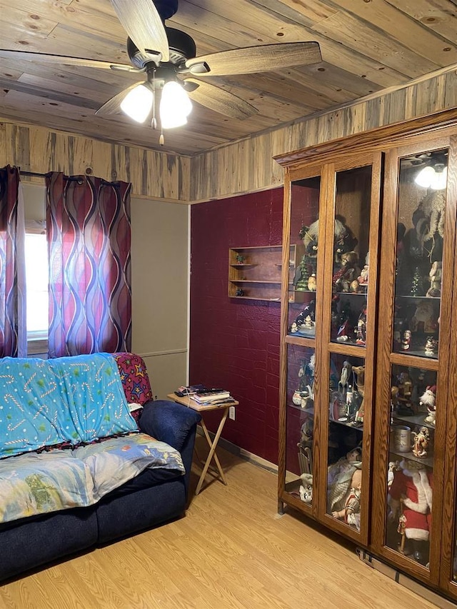 interior space featuring light wood-type flooring, wood ceiling, and ceiling fan