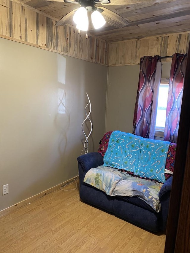 interior space featuring ceiling fan, wood finished floors, and wood ceiling