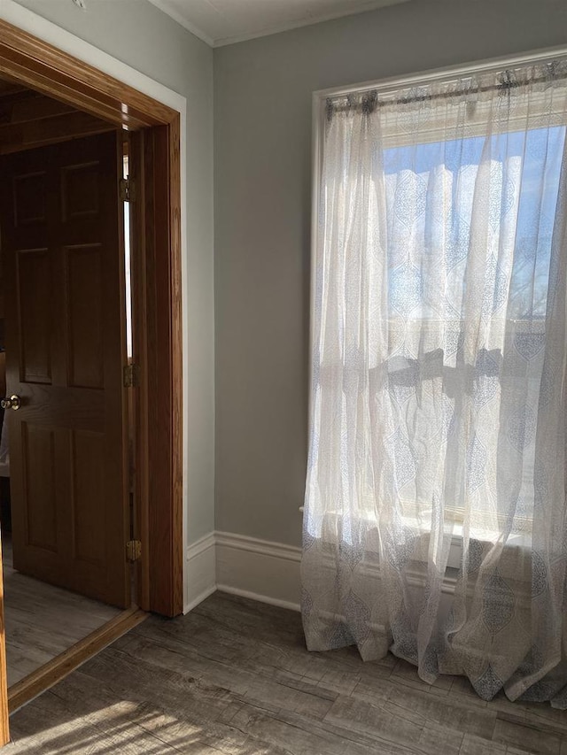 interior space featuring baseboards and wood finished floors