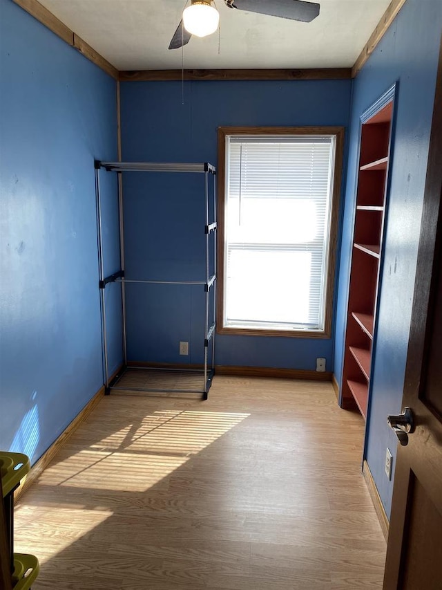 unfurnished bedroom featuring ceiling fan, baseboards, and wood finished floors