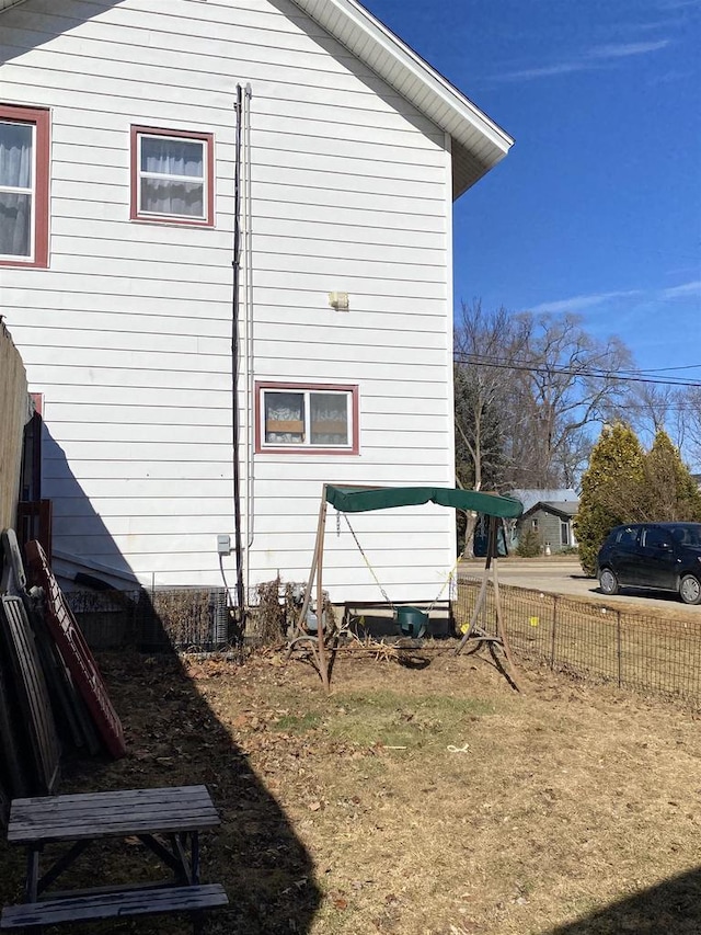 view of side of home with fence