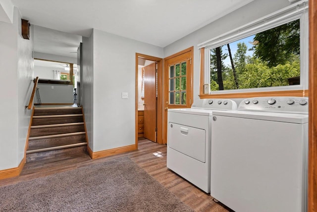 laundry room featuring a wealth of natural light, washer and dryer, laundry area, and light wood finished floors