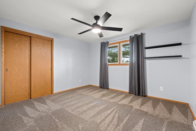 unfurnished bedroom featuring ceiling fan, carpet floors, a closet, and baseboards