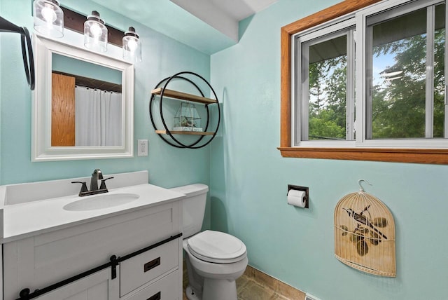 full bathroom with toilet and vanity