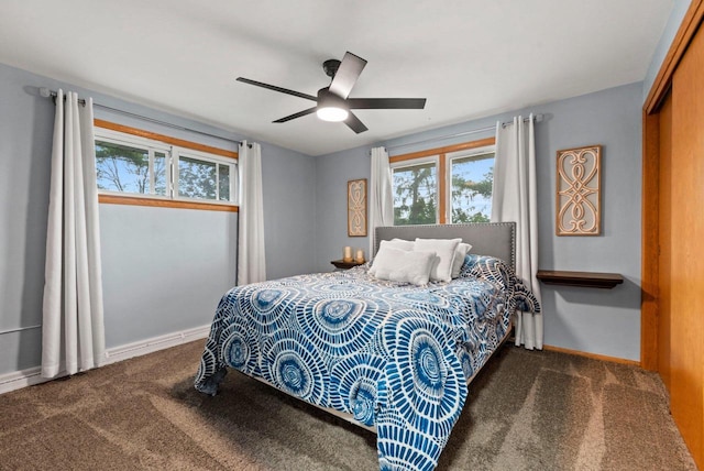 carpeted bedroom with baseboards and a ceiling fan