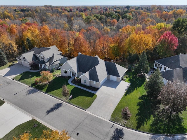 birds eye view of property featuring a wooded view