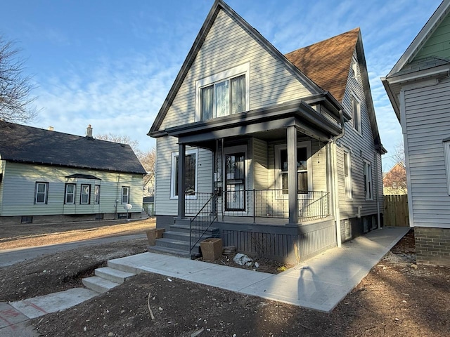 view of front of home featuring a shingled roof and covered porch