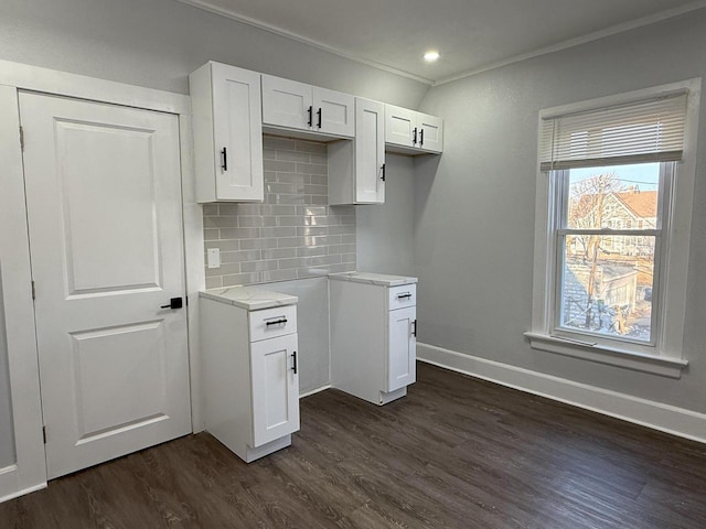 kitchen featuring baseboards, white cabinetry, decorative backsplash, and dark wood-style flooring