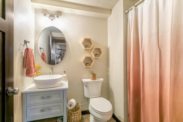 bathroom featuring toilet, curtained shower, and vanity