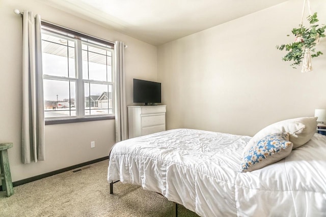 bedroom featuring carpet flooring, visible vents, and baseboards