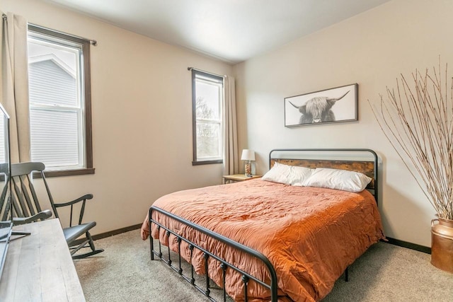 carpeted bedroom featuring baseboards