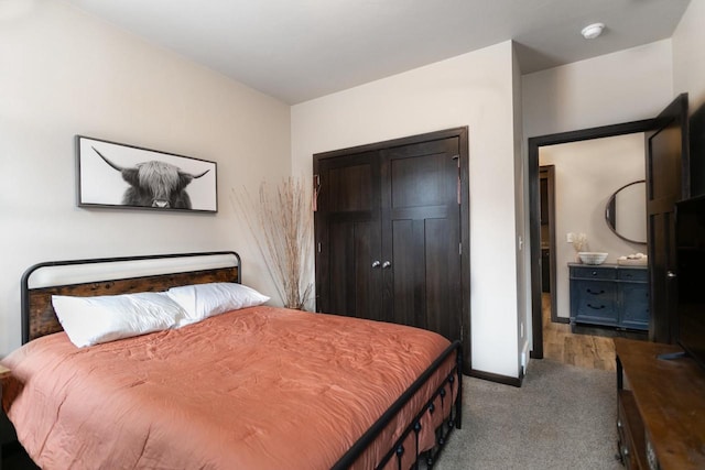 bedroom featuring carpet, a closet, and baseboards