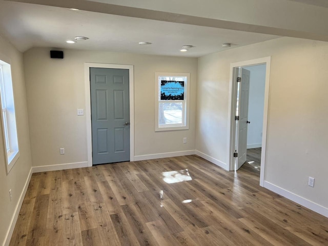 entryway with wood finished floors and baseboards