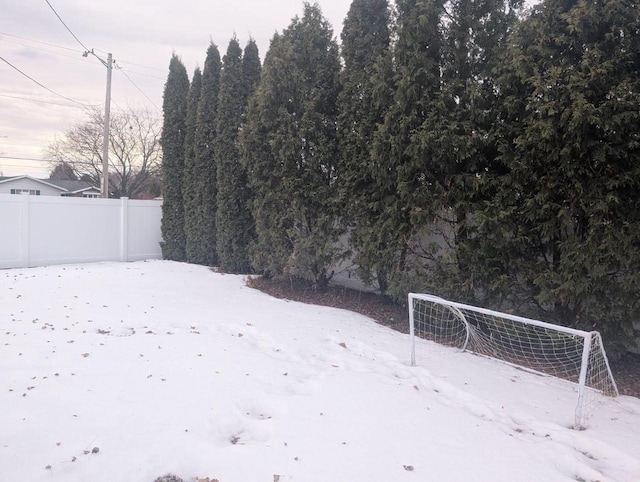 snowy yard with fence