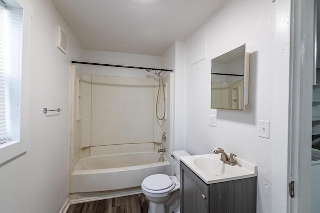 full bath with visible vents, toilet, wood finished floors, vanity, and washtub / shower combination