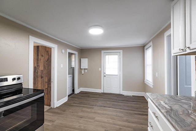 kitchen with dark wood-style floors, electric stove, and ornamental molding