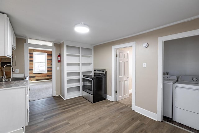 kitchen with wood finished floors, a sink, white cabinets, and stainless steel electric stove