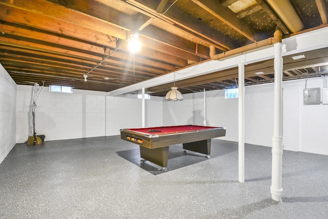 basement featuring electric panel, a wealth of natural light, and pool table