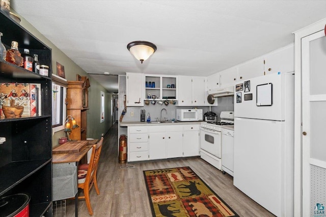 kitchen featuring dark wood finished floors, open shelves, white cabinets, a sink, and white appliances