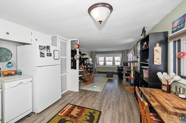 kitchen with light countertops, white appliances, wood finished floors, and white cabinetry