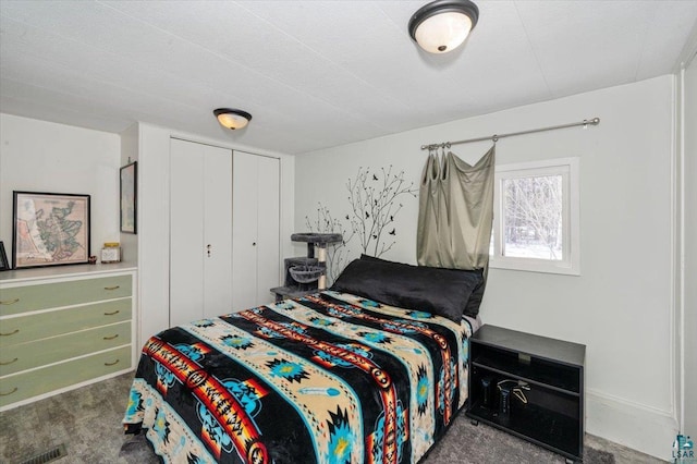 carpeted bedroom with a closet and visible vents