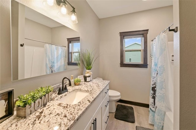 full bath with toilet, curtained shower, baseboards, and vanity