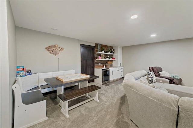 carpeted living area featuring a sink, beverage cooler, indoor wet bar, and recessed lighting