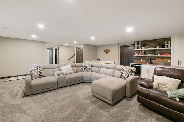 living area with beverage cooler, wet bar, light colored carpet, and recessed lighting