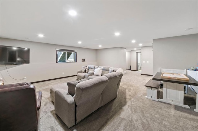 carpeted living area featuring baseboards and recessed lighting