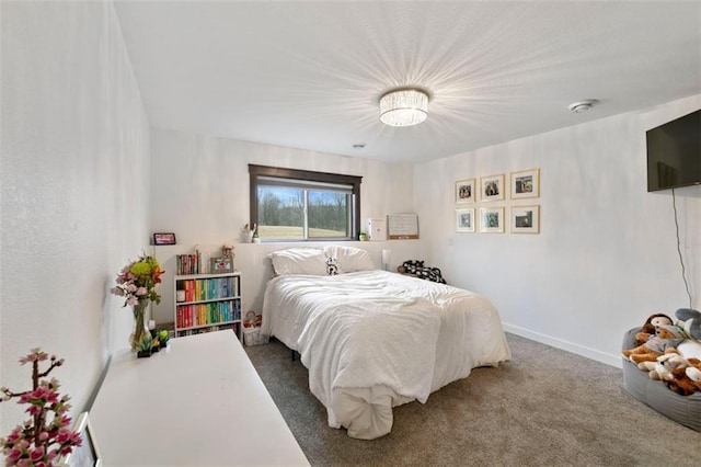 bedroom featuring carpet floors and baseboards