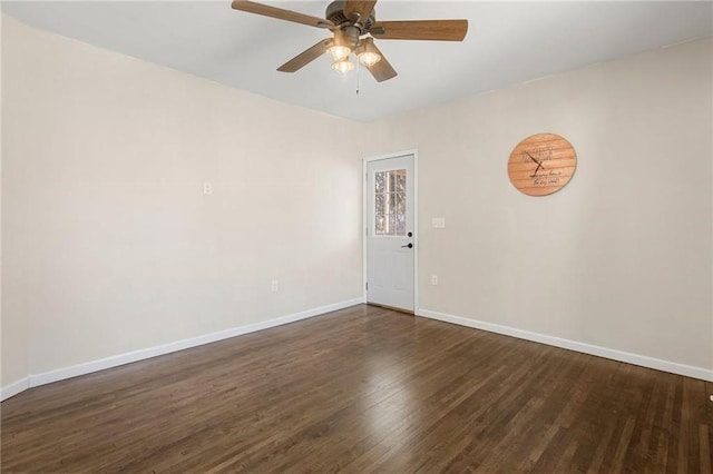 unfurnished room featuring a ceiling fan, baseboards, and dark wood-style flooring