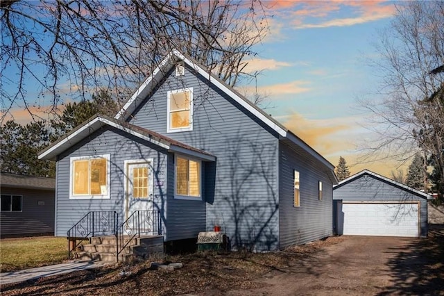 view of front of house featuring a garage and an outdoor structure