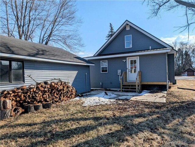 back of property featuring entry steps