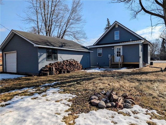 view of front of property with entry steps, an outdoor structure, and a detached garage