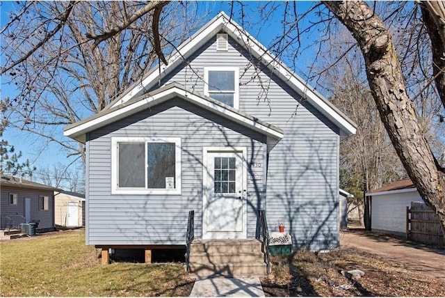 bungalow-style house featuring a front yard