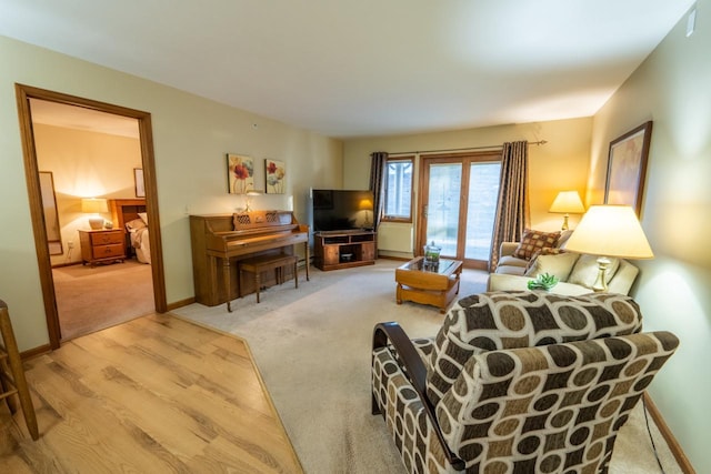 carpeted living area with baseboards