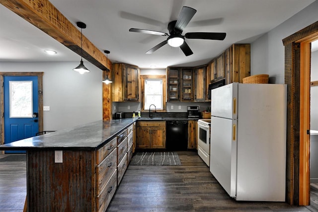 kitchen with white appliances, dark wood finished floors, dark countertops, a peninsula, and hanging light fixtures